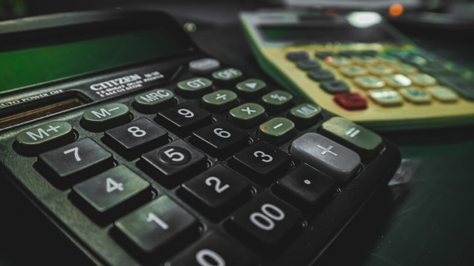 assets and liabilities on a balance sheet with a simple calculator, ledger, and upward trend line